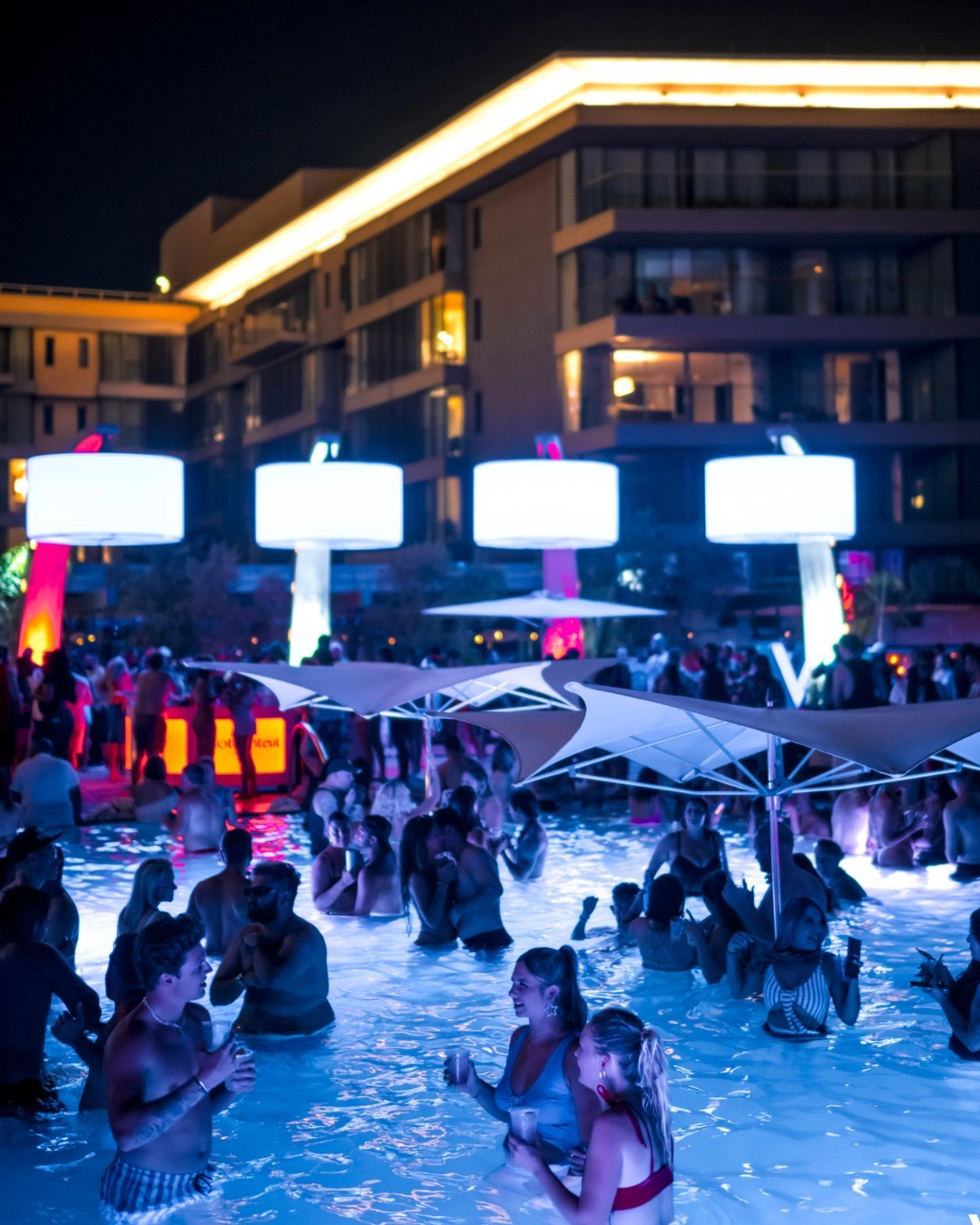 The WET Deck pool lit up at night